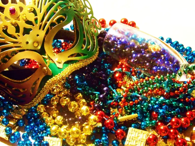 Mardi Gras mask with beads and champagne flute