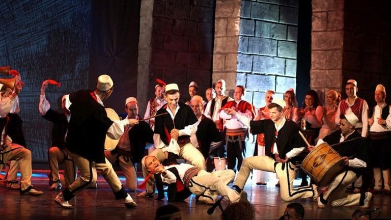 dancers in traditional Albanian costume perform featuring Genci Kastrati